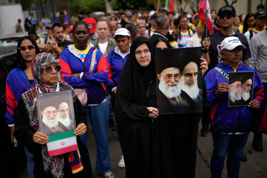 people-some-holding-images-of-late-supreme-leaders-ayatollah-ali-khamenei-and-ruhollah-khomeini-the-founder-of-the-islamic-republic-of-iran-stand-outside-the-iranian-embassy-to-protest-against-the