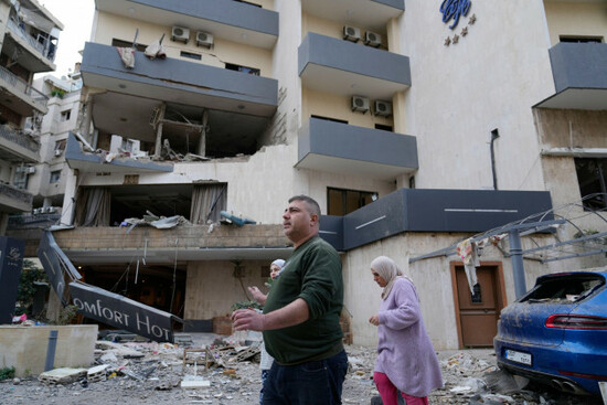 people-pass-in-front-of-a-damaged-hotel-that-was-hit-by-an-israeli-airstrike-in-hazmieh-east-of-beirut-lebanon-wednesday-march-4-2026-ap-photohussein-malla