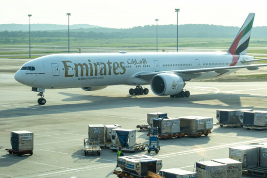 boeing-777-300er-aircraft-operated-by-emirates-airlines-parked-on-the-tarmac-preparing-for-cargo-loading-or-unloading-kuala-lumpur