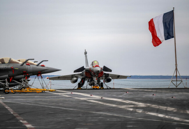 the-tricolor-flies-next-to-a-row-of-rafale-m-marine-fighter-jets-parked-on-the-flight-deck-as-the-french-aircraft-carrier-charles-de-gaulle-r91-was-shown-to-the-media-and-guests-on-wednesday-as-it