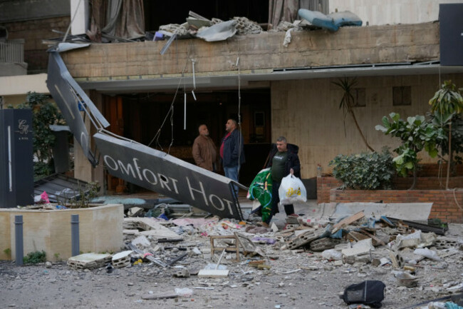 a-man-carries-his-belongings-as-he-leaves-a-damaged-hotel-that-was-hit-by-an-israeli-airstrike-in-hazmieh-east-of-beirut-lebanon-wednesday-march-4-2026-ap-photohussein-malla