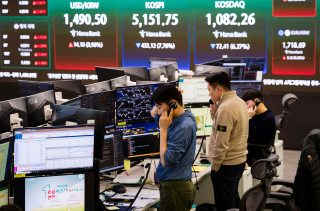 seoul-south-korea-9th-mar-2026-the-usdkrw-exchange-rate-and-prices-for-the-kospi-and-kosdaq-stock-indexes-are-shown-on-screen-as-traders-work-on-the-trading-room-floor-at-hana-bank-in-seoul-sout