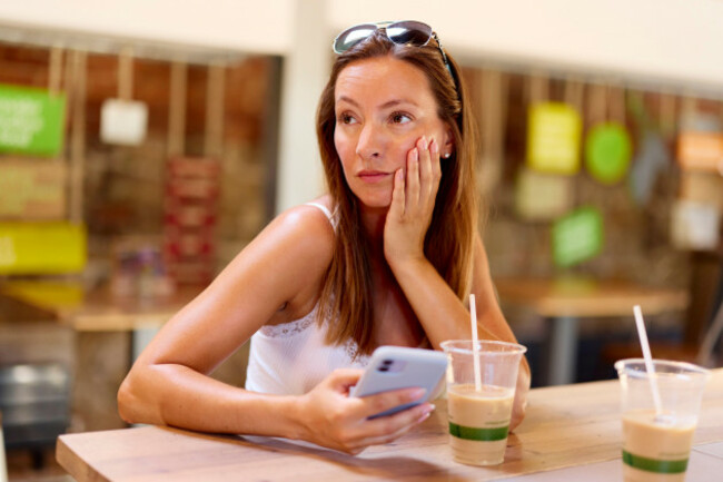 woman-looking-shocked-looking-at-message