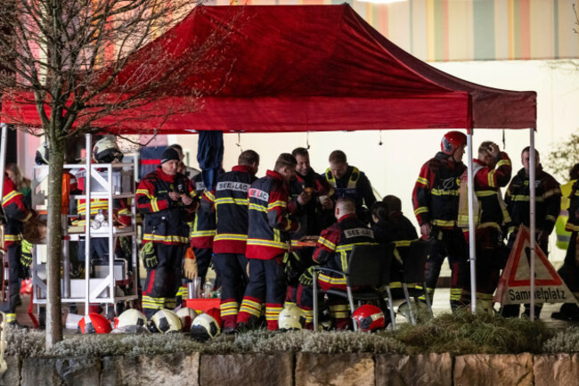 firemen-gather-next-to-the-charred-shell-of-a-postal-bus-not-pictured-which-caught-fire-killing-several-people-and-injuring-others-in-kerzers-switzerland-tuesday-march-10-2026-alessandro-dell