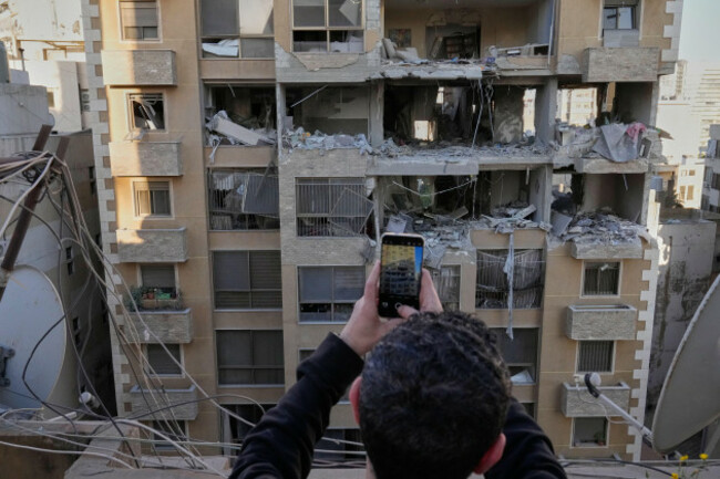 a-man-takes-pictures-of-destroyed-apartments-that-were-hit-by-israeli-airstrikes-in-beirut-lebanon-wednesday-march-11-2026-ap-photohussein-malla