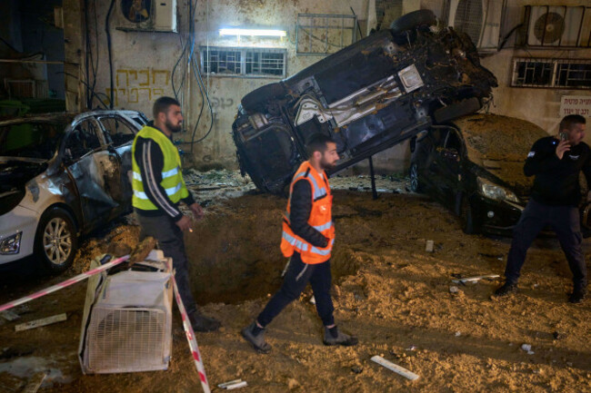 israeli-security-forces-inspect-damage-at-the-site-of-an-iranian-missile-strike-in-holon-central-israel-sunday-march-15-2026-ap-photoohad-zwigenberg