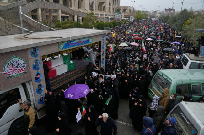 iranians-follow-a-truck-carrying-the-flag-draped-coffins-of-irans-intelligence-minister-esmail-khatib-and-according-to-iranian-officials-his-wife-and-daughter-during-a-funeral-procession-in-tehran