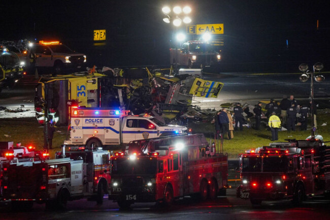 a-port-authority-aircraft-rescue-and-firefighting-vehicle-lays-on-its-side-off-of-runway-4-after-colliding-with-an-air-canada-jet-after-it-landed-at-laguardia-airport-monday-march-23-2026-in-new-y