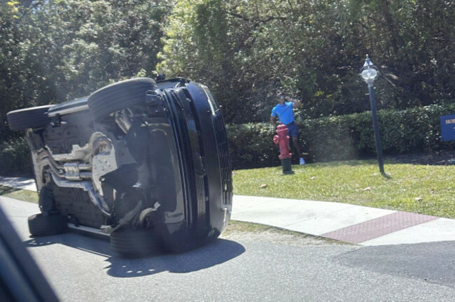 golfer-tiger-woods-stands-by-his-overturned-vehicle-in-jupiter-island-fla-on-friday-march-27-2026-ap-photojason-oteri