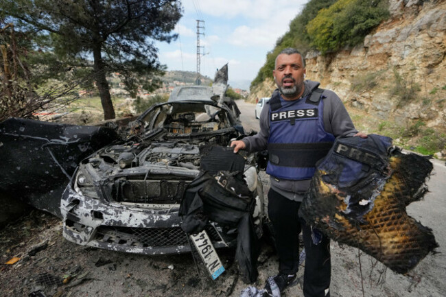 a-journalist-carries-burned-safety-gear-following-an-israeli-airstrike-on-a-car-that-killed-hezbollahs-al-manar-tv-correspondent-ali-shoeib-beiruts-based-al-mayadeen-tv-reporter-fatima-ftouni-and