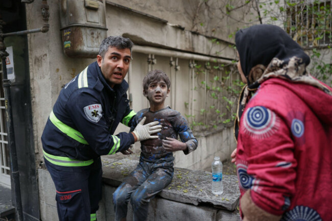 a-first-responder-assists-an-injured-boy-following-a-strike-that-hit-a-residential-building-amid-the-u-s-israeli-military-campaign-in-tehran-iran-saturday-march-28-2026-ap-photosajad-safari