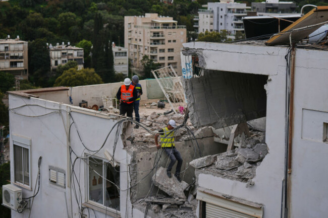 israeli-authorities-inspect-a-damaged-house-following-an-iranian-missile-strike-in-haifa-israel-monday-march-30-2026-ap-photoariel-schalit