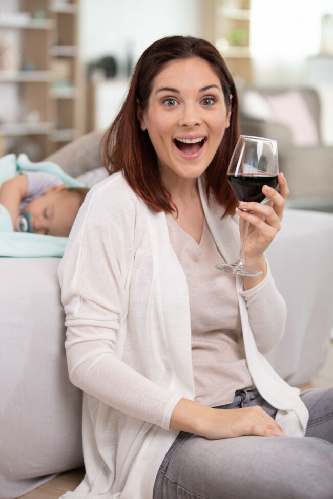smiling-mother-holding-a-glass-of-red-wine