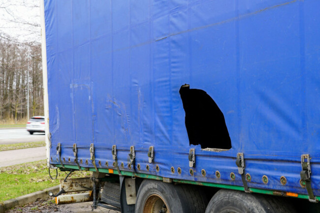 truck-trailer-with-blue-damaged-awning-cargo-theft-problem-by-cutting-the-awning-goods-thefts-from-cargo-trailers-goods-stealing-cut-awning
