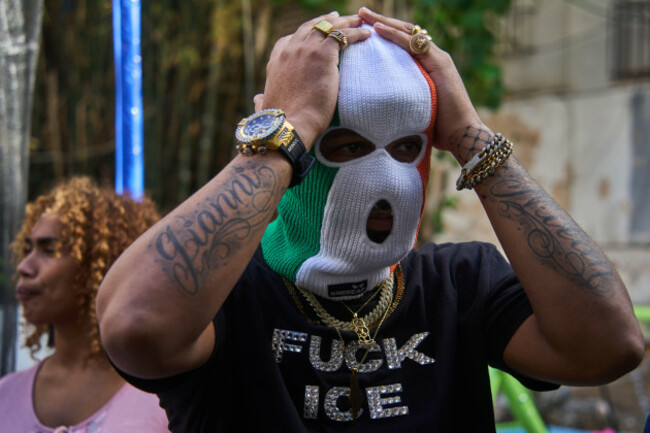 eds-note-obscenity-a-friend-of-the-irish-language-rap-trio-kneecap-waits-for-the-start-of-their-concert-as-part-of-the-our-america-convoy-in-havana-cuba-saturday-march-21-2026-ap-photoramon