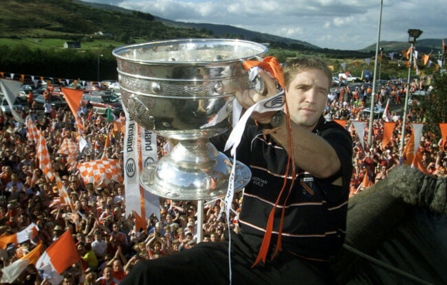armagh-captain-kieran-mcgeeney-holds-aloft-the-sam-maguire-cup-as-the-victorious-gaelic-football-team-heads-back-to-northern-ireland-thousands-of-fans-gathered-to-greet-the-team-after-their-historic