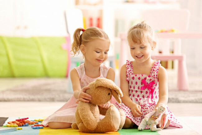 cheerful-little-girls-playing-on-floor