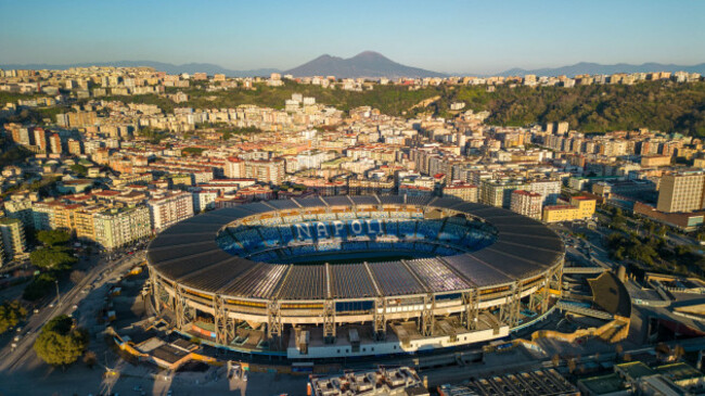 beautiful-aerial-view-above-diego-armando-maradona-stadium-with-mount-vesuvius-in-background-at-golden-hour-drone-shot