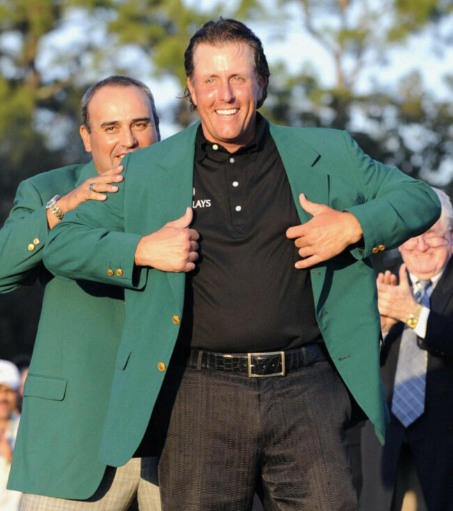 augusta-united-states-phil-mickelson-of-the-united-states-l-receives-the-green-jacket-from-angel-cabrera-of-argentina-after-winning-the-masters-golf-tournament-at-the-augusta-national-golf-club-i