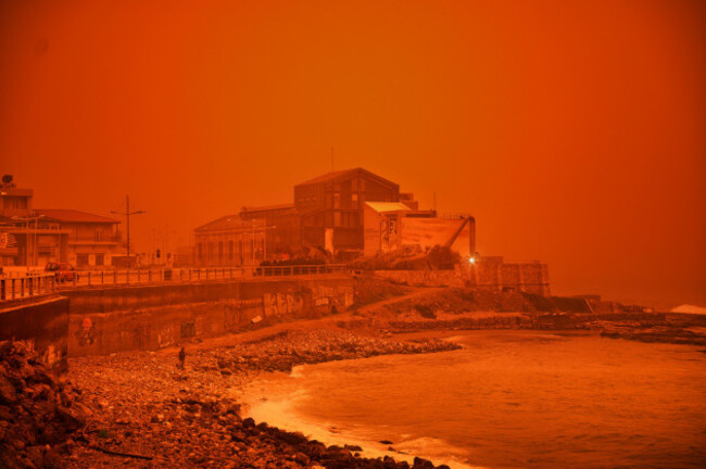 a-man-walks-at-a-beach-during-a-dust-storm-in-iraklio-on-the-southern-island-of-crete-greece-wednesday-april-1-2026-ap-photogiorgos-gkratsos-correction-day-corrected-to-wednesday-instead-of