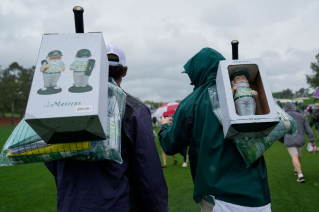 patrons-exit-with-masters-gnomes-after-play-was-suspended-due-to-weather-after-a-practice-round-at-the-masters-golf-tournament-monday-april-7-2025-in-augusta-ga-ap-photoashley-landis