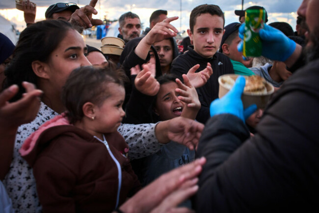displaced-people-wait-to-receive-donated-food-beside-the-tents-they-use-as-shelters-after-fleeing-israeli-bombardment-in-southern-lebanon-in-beirut-lebanon-monday-april-6-2026-ap-photoemilio-m