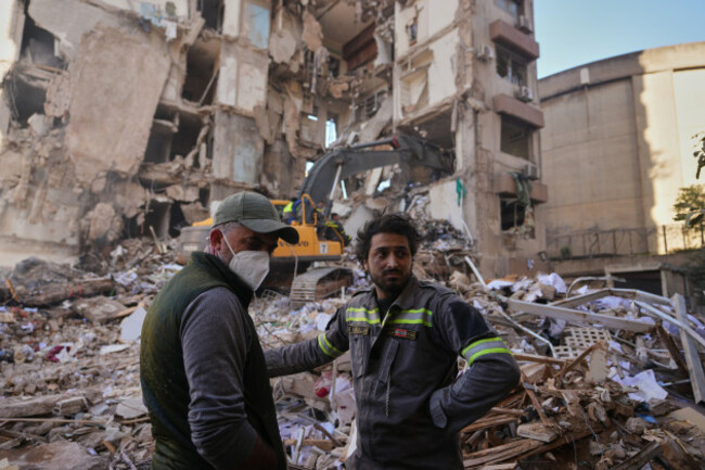 a-lebanese-civil-defense-worker-right-stands-with-a-resident-at-the-site-of-a-building-destroyed-in-an-israeli-airstrike-a-day-earlier-in-central-beirut-lebanon-thursday-april-9-2026-ap-photo