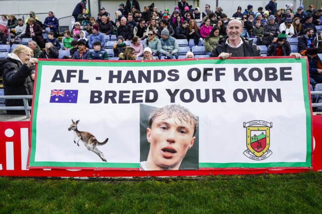 tom-and-pauline-mcdonald-with-a-banner-ahead-of-the-game