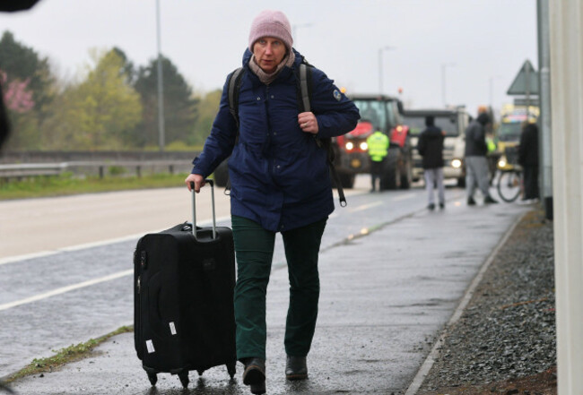 a-person-with-their-luggage-walking-on-sydenham-by-pass-in-belfast-towards-belfast-airport-as-the-national-fuel-protest-against-rising-fuel-prices-continues-to-cause-delays-picture-date-tuesday-apr