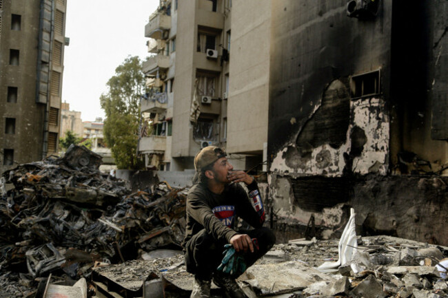 beirut-beirut-lebanon-14th-apr-2026-abdo-a-17-year-old-scrap-collector-takes-rest-as-he-sits-in-front-of-burned-cars-at-the-site-of-an-israeli-air-strike-in-beirut-lebanon-and-israel-are-holdin