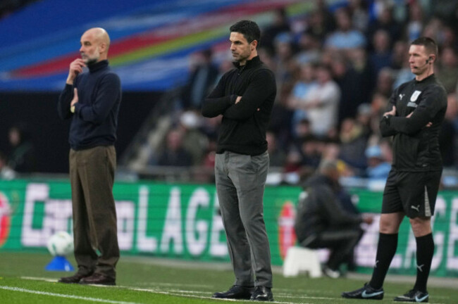 arsenals-manager-mikel-arteta-center-watches-his-players-from-the-sidelines-with-manchester-citys-head-coach-pep-guardiola-left-during-the-english-league-cup-final-soccer-match-between-arsenal