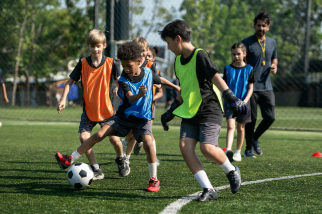 group-of-international-school-kids-playing-soccer-together-on-the-field-showing-teamwork-diversity-and-active-childhood-lifestyle