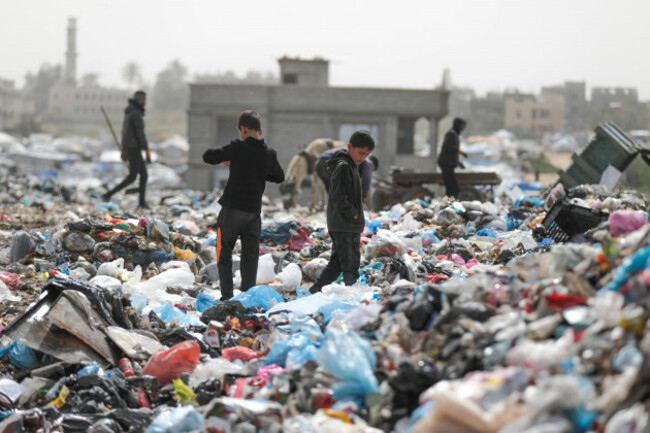 palestinian-children-search-through-piles-of-garbage-for-leftover-food-or-toys-at-a-landfill-in-al-bureij-refugee-camp-in-the-central-gaza-strip-palestinian-children-search-through-piles-of-garbage-f