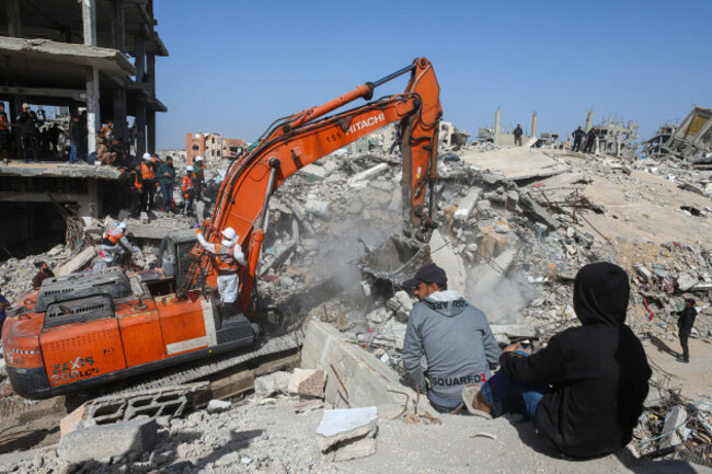 gaza-palestine-15th-feb-2026-civil-defense-teams-in-coordination-with-officials-from-the-international-committee-of-the-red-cross-icrc-use-heavy-machinery-to-search-the-rubble-of-a-destroyed-b