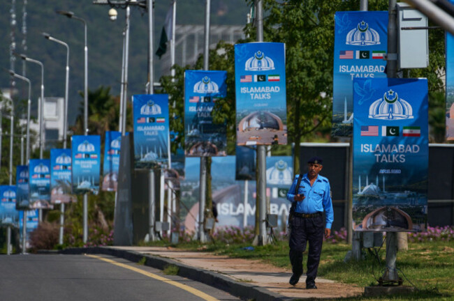 a-police-officer-walks-past-billboards-near-the-serena-hotel-ahead-of-the-second-round-of-negotiations-between-the-u-s-and-iran-in-islamabad-pakistan-tuesday-april-21-2026-ap-photoanjum-navee