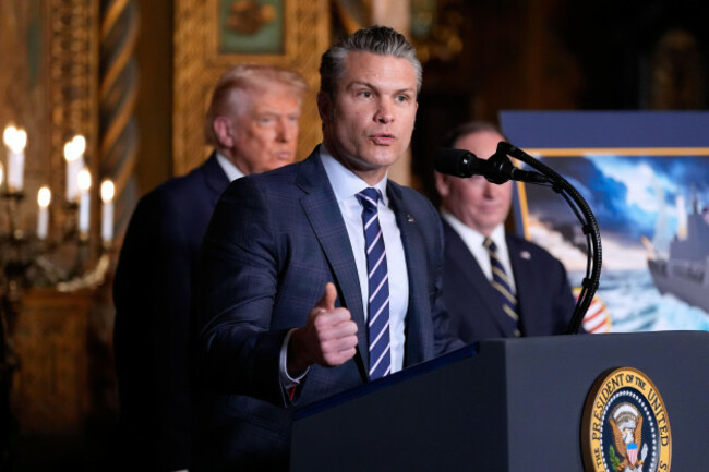 defense-secretary-pete-hegseth-speaks-as-president-donald-trump-and-navy-john-phelan-look-on-at-his-mar-a-lago-club-monday-dec-22-2025-in-palm-beach-fla-ap-photoalex-brandon