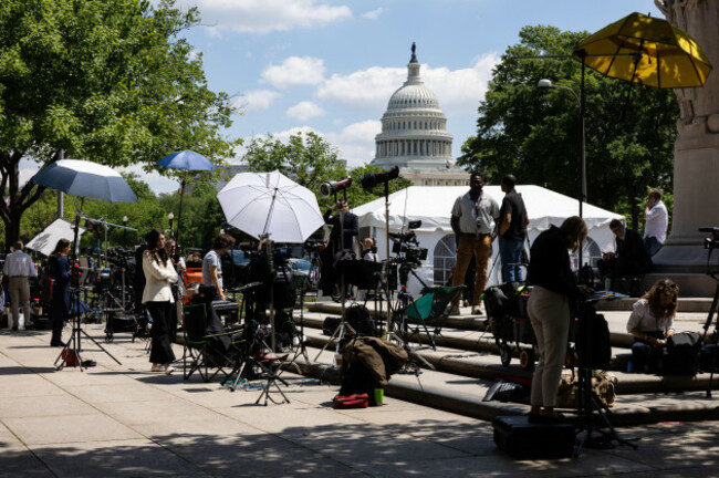 the-u-s-capitol-building-is-seen-while-in-the-foreground-journalists-wait-outside-the-e-barrett-prettyman-u-s-courthouse-before-the-arraignment-of-white-house-correspondents-dinner-shooting-susp