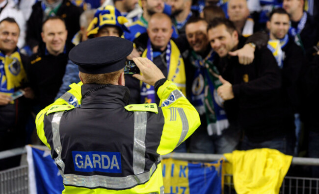 euro-qualifier-ireland-vs-bosnia-dublin-ireland-16th-november-2015a-member-of-the-garda-takes-photos-of-the-bosnian-fans-for-them-police-fans