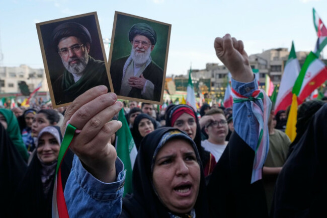a-woman-holds-up-pictures-of-the-iranian-supreme-leader-ayatollah-mojtaba-khamenei-left-and-his-father-the-slain-ayatollah-ali-khamenei-in-a-state-organised-rally-celebrating-the-birthday-of-imam-r