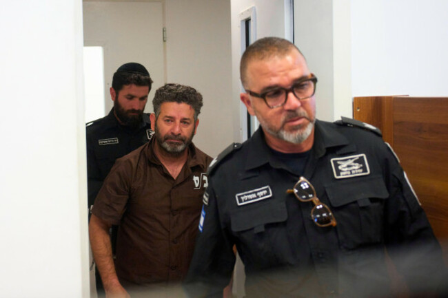 palestinian-spanish-activist-saif-abukeshek-center-a-member-of-the-global-sumud-flotilla-is-escorted-by-prison-service-guards-to-a-hearing-at-the-district-court-in-ashkelon-israel-on-sunday-may