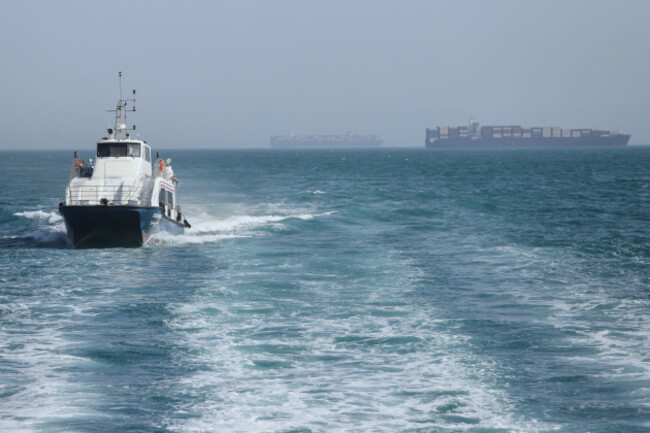 a-patrol-boat-moves-through-the-water-as-cargo-ships-sit-at-anchor-in-the-strait-of-hormuz-off-bandar-abbas-iran-saturday-may-2-2026-amirhosein-khorgooiisna-via-ap