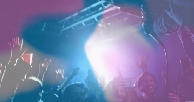 raising-hands-and-phones-concert-fans-recording-live-music-at-music-hall-with-spotlights-and-haze