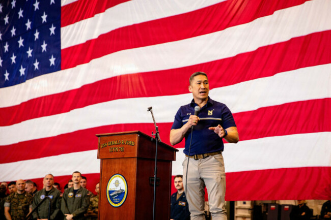 uss-gerald-ford-international-waters-04-may-2026-u-s-acting-secretary-of-the-navy-hung-cao-right-addresses-sailors-at-an-all-hands-call-in-the-hangar-bay-of-the-ford-class-aircraft-carrier-uss