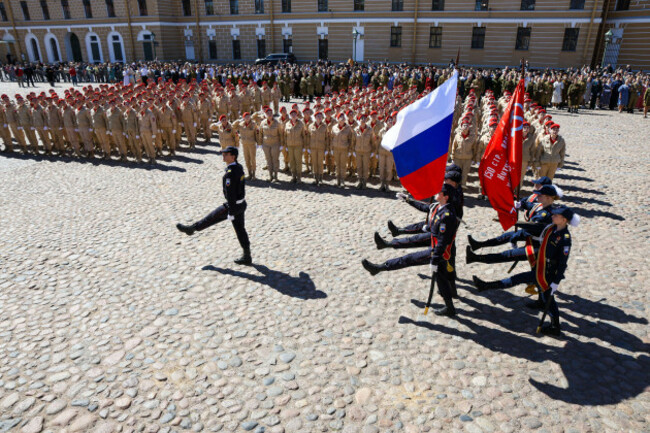 a-ceremonial-group-carries-the-national-flag-of-russia-and-the-victory-banner-across-cathedral-square-during-the-opening-of-the-victory-ball-reconstruction-a-large-scale-theatrical-reconstruction-a