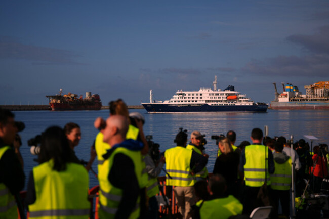 media-and-emergency-services-personnel-work-next-the-hantavirus-stricken-cruise-ship-mv-hondius-after-its-arrival-at-the-port-of-granadilla-in-tenerife-canary-islands-spain-sunday-may-10-2026-a
