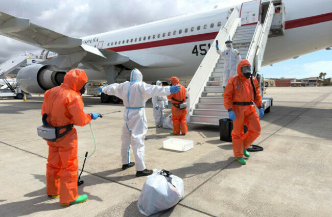 a-spanish-passenger-is-sprayed-with-disinfectant-by-spanish-government-officials-before-boarding-a-plane-after-disembarking-from-the-hantavirus-stricken-cruise-ship-mv-hondius-at-tenerife-airport-in-t