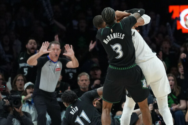minnesota-timberwolves-center-naz-reid-11-falls-to-the-court-after-he-was-fouled-by-san-antonio-spurs-forward-victor-wembanyama-1-as-he-and-forward-jaden-mcdaniels-3-battled-for-a-rebound-during