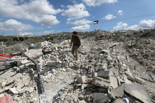 jenin-25th-feb-2026-a-palestinian-inspects-the-rubble-of-a-house-after-an-israeli-military-bulldozer-demolished-it-in-the-village-of-anza-south-of-jenin-in-the-west-bank-on-feb-25-2026-credit