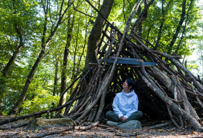 woman-survivalist-in-a-campsite-in-the-forest