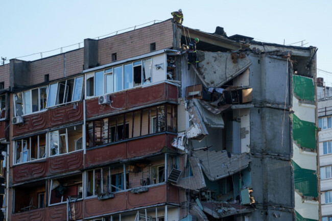 a-rescue-worker-downs-on-a-rope-from-the-roof-of-a-house-heavily-damaged-after-a-russian-strike-on-residential-neighbourhood-in-kyiv-ukraine-on-thursday-may-14-2026-ap-photoevgeniy-maloletka